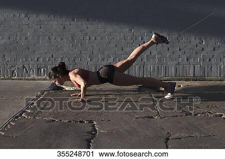 Woman doing push-ups in a street View Large Photo Image Stock Image - Woman doing push-ups in a street. Fotosearch