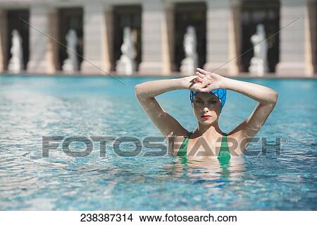 Picture - Woman doing water aerobics in a swimming pool, Biltmore Hotel, Coral Gables, Florida, USA. Fotosearch