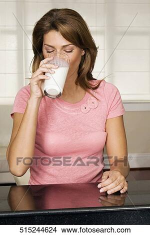 Woman drinking milk from a glass View Large Photo Image Picture - Woman drinking milk from a glass. Fotosearch
