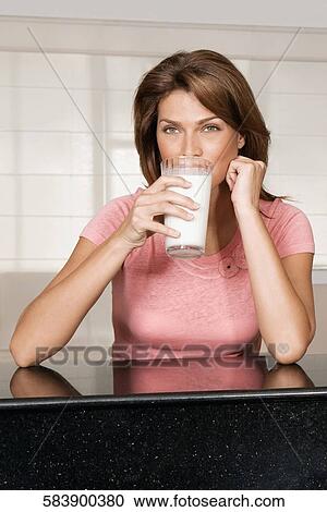 Woman drinking milk from a glass View Large Photo Image Stock Image - Woman drinking milk from a glass. Fotosearch