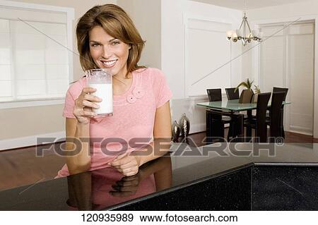 Woman drinking milk from a glass View Large Photo Image Stock Photo - Woman drinking milk from a glass. Fotosearch