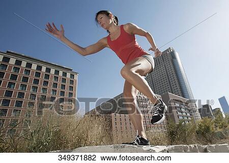 Woman exercising on a stone View Large Photo Image Stock Image - Woman exercising on a stone. Fotosearch