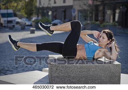 Woman exercising on a stone View Large Photo Image Stock Image - Woman exercising on a stone. Fotosearch