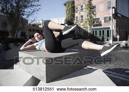 Woman exercising on a stone View Large Photo Image Stock Image - Woman exercising on a stone. Fotosearch