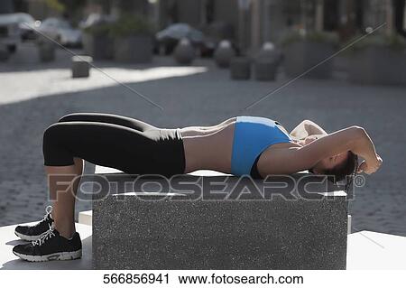 Woman exercising on a stone View Large Photo Image Stock Image - Woman exercising on a stone. Fotosearch