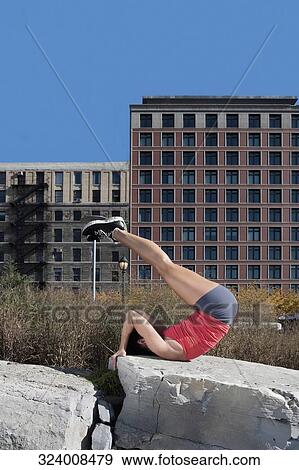 Woman exercising on a stone View Large Photo Image Stock Photo - Woman exercising on a stone. Fotosearch