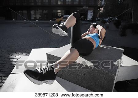 Woman exercising on a stone View Large Photo Image Stock Photo - Woman exercising on a stone. Fotosearch