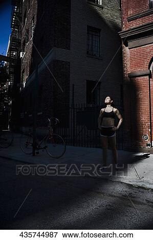 Stock Photo - Woman exercising with arms akimbo. Fotosearch