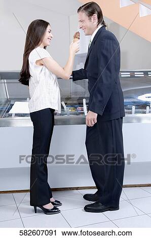 Woman feeding ice cream to a man View Large Photo Image Stock Image - Woman feeding ice cream to a man. Fotosearch