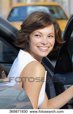 Woman getting out of a car and smiling, Biltmore Hotel, Coral Gables, Florida, USA View Large Photo Image Stock Image - Woman getting out of a car and smiling, Biltmore Hotel, Coral Gables, Florida, USA. Fotosearch