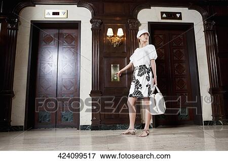 Woman holding a bag in a hotel lobby, Biltmore Hotel, Coral Gables, Florida, USA View Large Photo Image Stock Photo - Woman holding a bag in a hotel lobby, Biltmore Hotel, Coral Gables, Florida, USA. Fotosearch