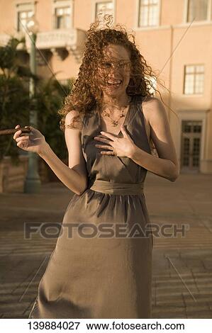 Woman holding a cigar and laughing, Biltmore Hotel, Coral Gables, Florida, USA View Large Photo Image Stock Photo - Woman holding a cigar and laughing, Biltmore Hotel, Coral Gables, Florida, USA. Fotosearch
