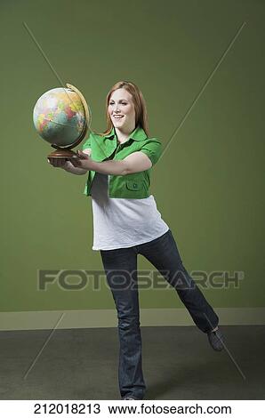 Woman holding a globe View Large Photo Image Stock Image - Woman holding a globe. Fotosearch
