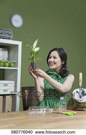 Woman holding a seedling View Large Photo Image Stock Image - Woman holding a seedling. Fotosearch