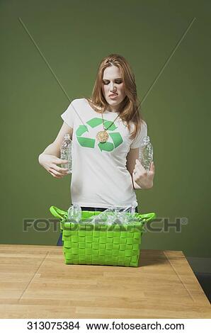 Woman holding plastic bottles View Large Photo Image Picture - Woman holding plastic bottles. Fotosearch