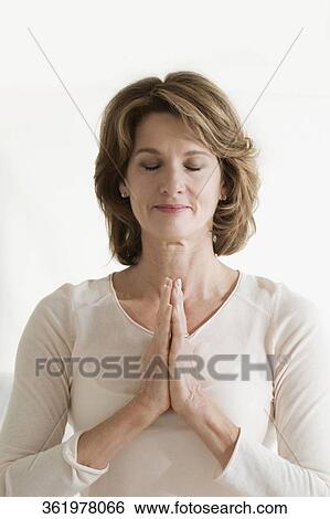 Woman in a prayer position View Large Photo Image Stock Photograph - Woman in a prayer position. Fotosearch