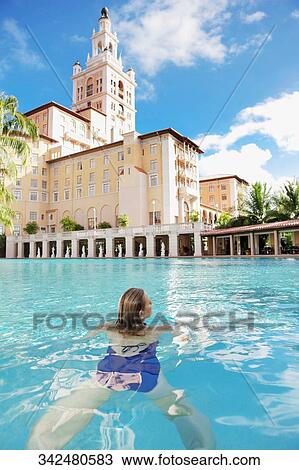 Woman in a swimming pool, Biltmore Hotel, Coral Gables, Florida, USA View Large Photo Image Stock Image - Woman in a swimming pool, Biltmore Hotel, Coral Gables, Florida, USA. Fotosearch