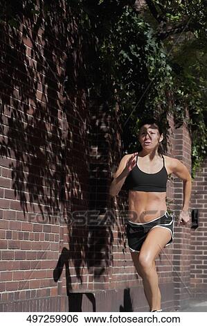 Woman jogging in a street View Large Photo Image Stock Photograph - Woman jogging in a street. Fotosearch