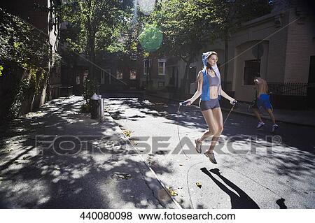 Woman jumping with a rope in the street View Large Photo Image Stock Photo - Woman jumping with a rope in the street. Fotosearch