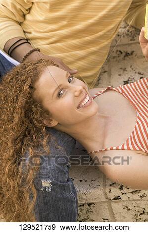 Stock Photo - Woman lying on her boyfriend's lap, Biltmore Hotel, Coral Gables, Florida, USA. Fotosearch