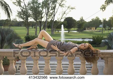 Woman lying on the balustrade in a hotel, Biltmore Hotel, Coral Gables, Florida, USA View Large Photo Image Stock Photograph - Woman lying on the balustrade in a hotel, Biltmore Hotel, Coral Gables, Florida, USA. Fotosearch