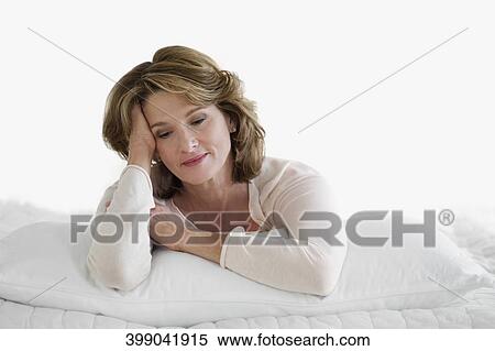 Woman lying on the bed and day dreaming View Large Photo Image Stock Photography - Woman lying on the bed and day dreaming. Fotosearch