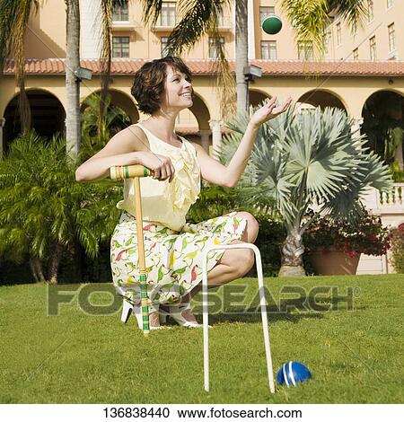 Stock Image - Woman playing croquet in a hotel lawn, Biltmore Hotel, Coral Gables, Florida, USA. Fotosearch