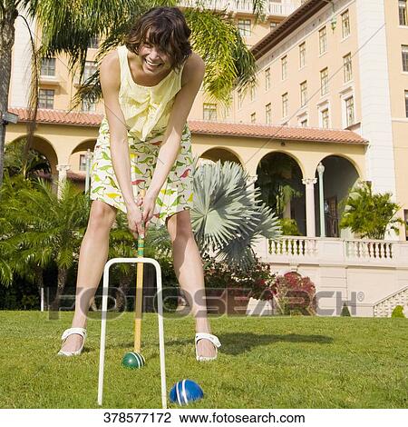Stock Image - Woman playing croquet in a hotel lawn, Biltmore Hotel, Coral Gables, Florida, USA. Fotosearch