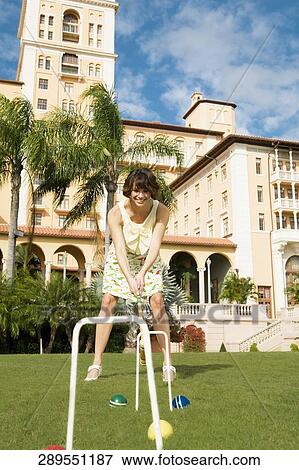 Woman playing croquet in a hotel lawn, Biltmore Hotel, Coral Gables, Florida, USA View Large Photo Image Stock Photo - Woman playing croquet in a hotel lawn, Biltmore Hotel, Coral Gables, Florida, USA. Fotosearch
