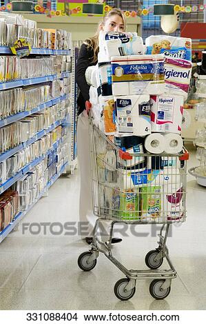 Woman pushing a shopping cart in a supermarket View Large Photo Image Picture - Woman pushing a shopping cart in a supermarket. Fotosearch