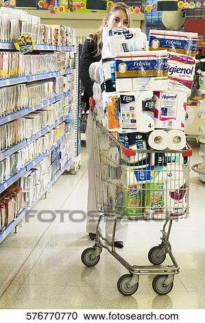 Woman pushing shopping cart loaded with toilet rolls View Large Photo Image Stock Image - Woman pushing shopping cart loaded with toilet rolls. Fotosearch