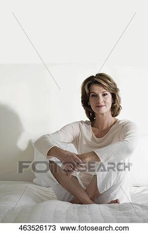 Woman relaxing on the bed View Large Photo Image Stock Image - Woman relaxing on the bed. Fotosearch