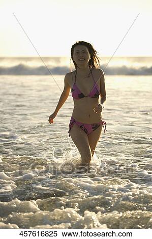 Woman running on the beach View Large Photo Image Stock Photography - Woman running on the beach. Fotosearch