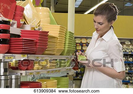 Woman shopping in a supermarket View Large Photo Image Picture - Woman shopping in a supermarket. Fotosearch