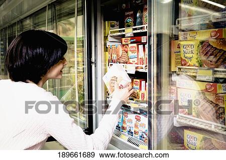 Woman shopping in a supermarket View Large Photo Image Stock Photo - Woman shopping in a supermarket. Fotosearch