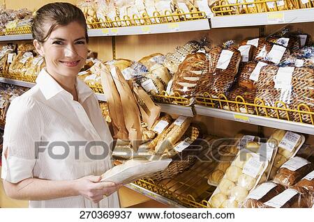 Woman shopping in a supermarket View Large Photo Image Stock Photo - Woman shopping in a supermarket. Fotosearch