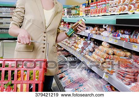 Woman shopping in a supermarket View Large Photo Image Stock Photo - Woman shopping in a supermarket. Fotosearch