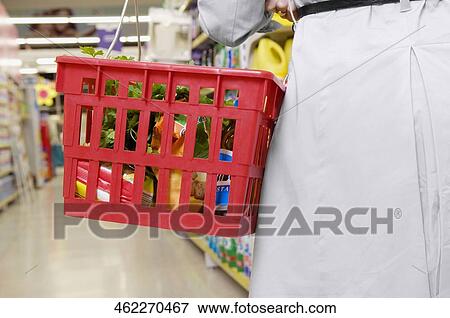 Woman shopping in a supermarket View Large Photo Image Stock Photo - Woman shopping in a supermarket. Fotosearch