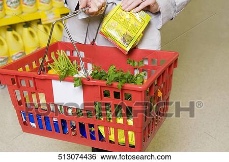Woman shopping in a supermarket View Large Photo Image Stock Photograph - Woman shopping in a supermarket. Fotosearch