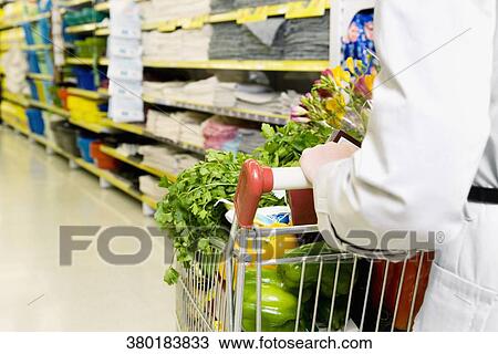 Woman shopping vegetables in a supermarket View Large Photo Image Stock Image - Woman shopping vegetables in a supermarket. Fotosearch
