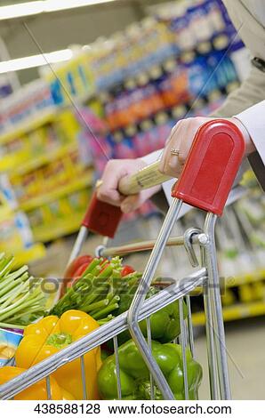 Woman shopping vegetables in a supermarket View Large Photo Image Stock Photo - Woman shopping vegetables in a supermarket. Fotosearch
