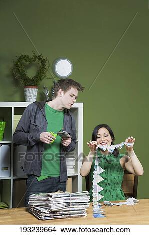 Woman showing a paper chain to a man View Large Photo Image Picture - Woman showing a paper chain to a man. Fotosearch