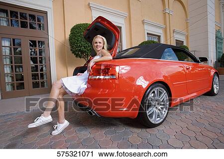 Woman sitting in a car trunk and smiling, Biltmore Hotel, Coral Gables, Florida, USA View Large Photo Image Stock Image - Woman sitting in a car trunk and smiling, Biltmore Hotel, Coral Gables, Florida, USA. Fotosearch