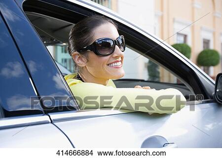 Woman smiling in a car, Biltmore Hotel, Coral Gables, Florida, USA View Large Photo Image Picture - Woman smiling in a car, Biltmore Hotel, Coral Gables, Florida, USA. Fotosearch