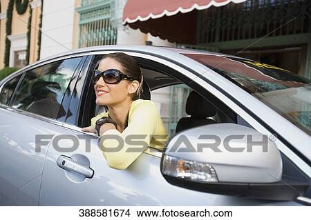 Woman smiling in a car in front of a hotel, Biltmore Hotel, Coral Gables, Florida, USA View Large Photo Image Picture - Woman smiling in a car in front of a hotel, Biltmore Hotel, Coral Gables, Florida, USA. Fotosearch
