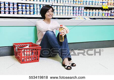 Woman smiling in a supermarket View Large Photo Image Stock Photo - Woman smiling in a supermarket. Fotosearch