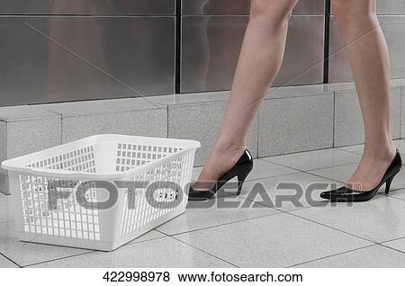 Woman standing in a laundromat View Large Photo Image Stock Photo - Woman standing in a laundromat. Fotosearch