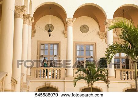 Stock Image - Woman standing in the balcony, Biltmore Hotel, Coral Gables, Florida, USA. Fotosearch