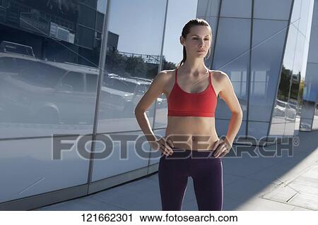 Woman standing with arms akimbo View Large Photo Image Stock Image - Woman standing with arms akimbo. Fotosearch