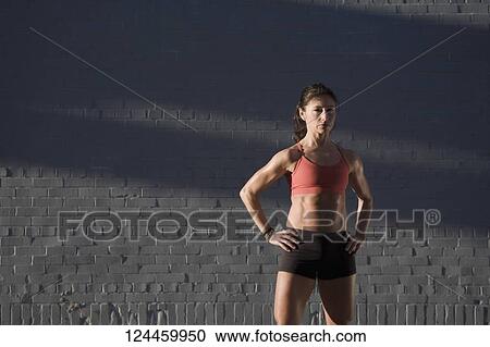 Woman standing with arms akimbo View Large Photo Image Stock Image - Woman standing with arms akimbo. Fotosearch